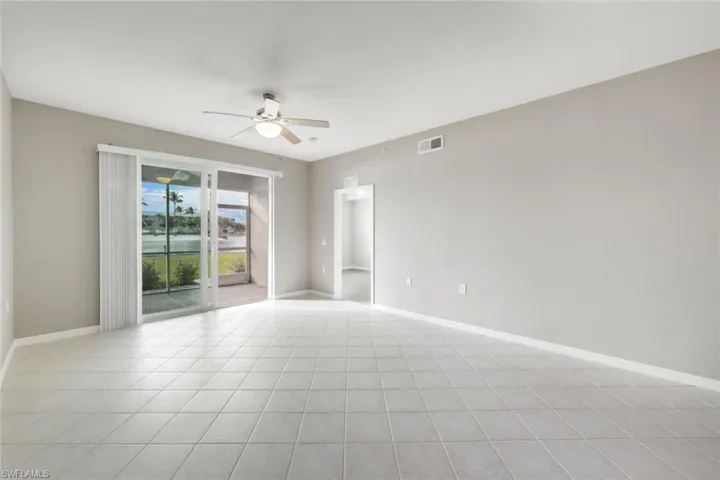 Unfurnished room with ceiling fan and light tile patterned floors