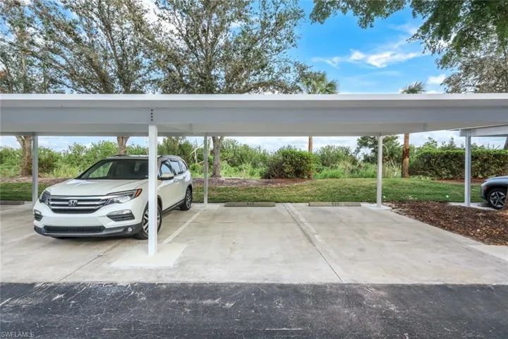 View of vehicle parking featuring a carport
