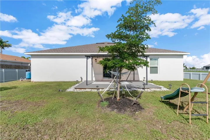 Back of property featuring a yard