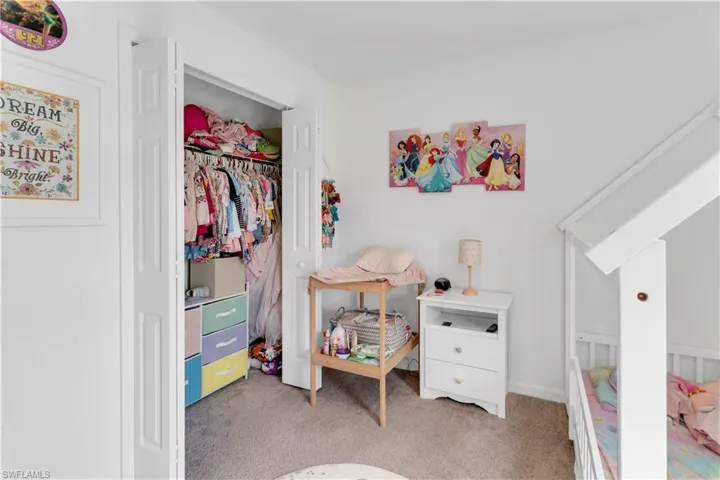 Bedroom with light colored carpet