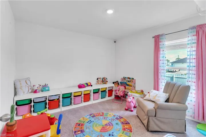 Rec room featuring light colored carpet
