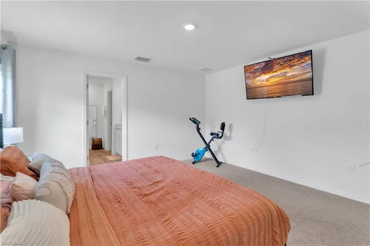 Carpeted bedroom with ensuite bath