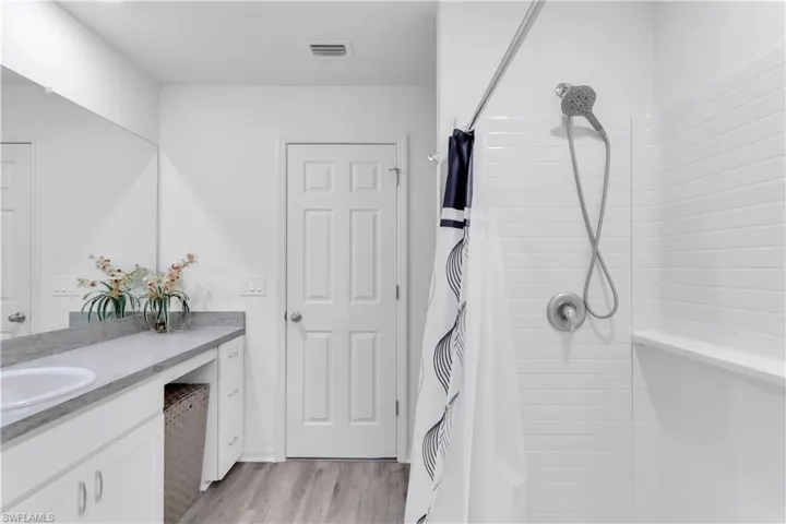 Bathroom featuring vanity, hardwood / wood-style floors, and a shower with shower curtain