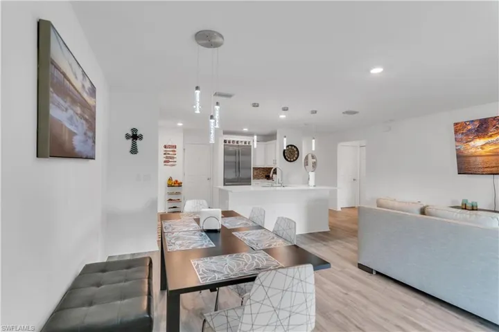 Dining room featuring sink and light hardwood / wood-style flooring