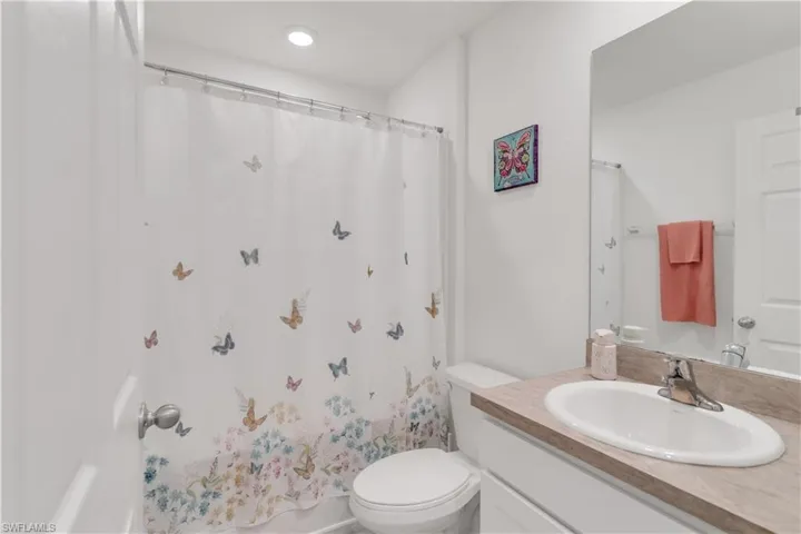 Full bathroom featuring toilet, shower with separate bathtub, and vanity