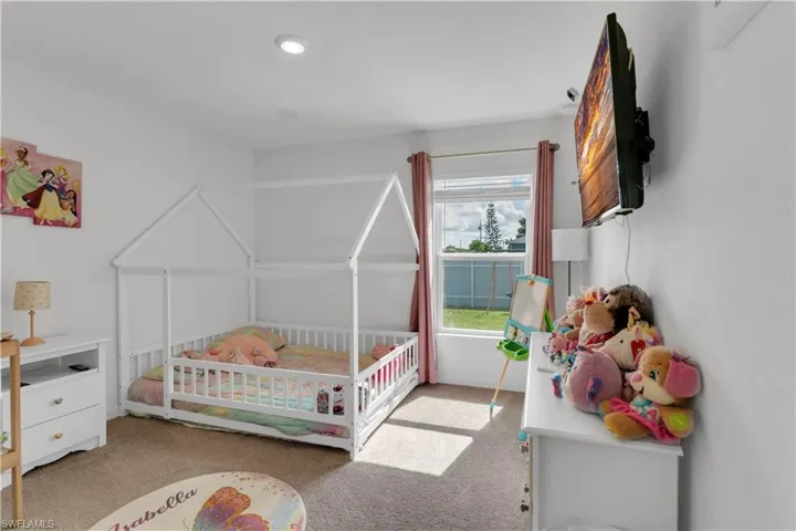 Carpeted bedroom with a nursery area