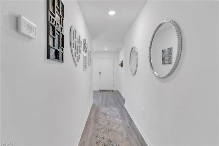 Corridor with light hardwood / wood-style flooring