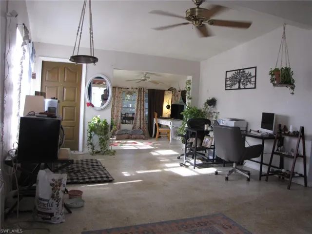 Office space featuring ceiling fan and lofted ceiling