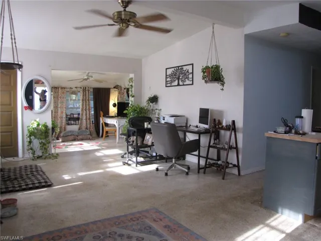 Office space with ceiling fan and vaulted ceiling