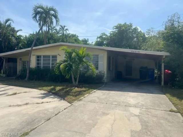 Ranch-style home featuring a carport