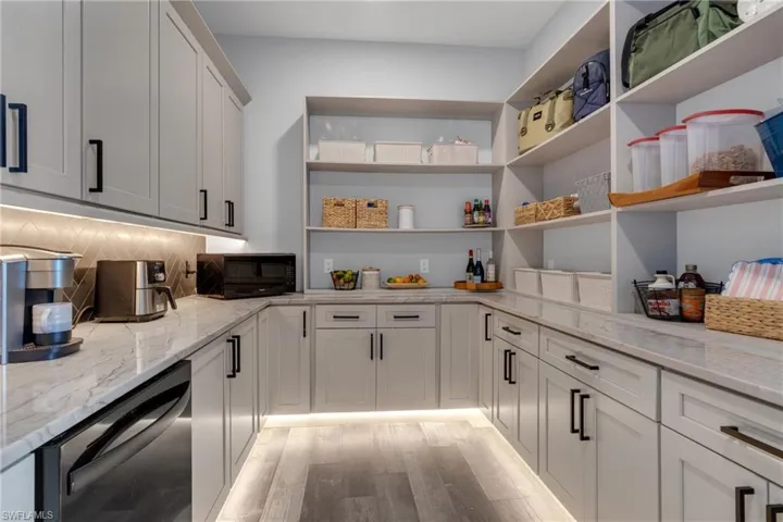 Walk-in Butlers Pantry with custom Pull out appliance shelves second dishwasher and sink