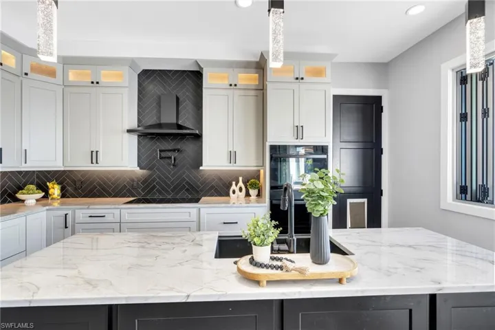 Gourmet  Kitchen with quartz countertops Tile backsplash and pot filler.