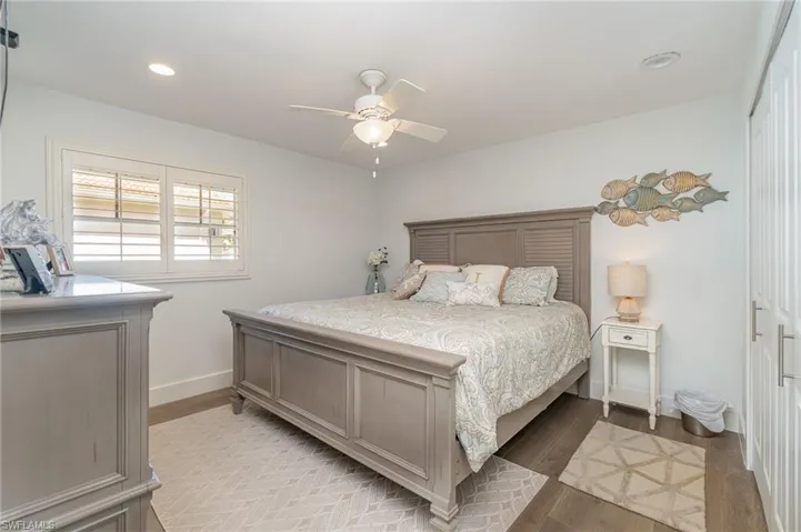 Bedroom with light hardwood / wood-style flooring and ceiling fan