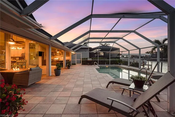 View of swimming pool with a patio and a lanai