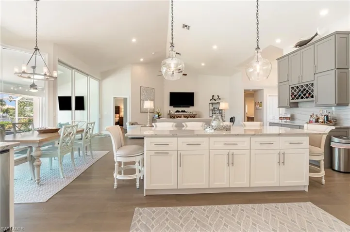 Kitchen with a kitchen bar, pendant lighting, and decorative backsplash