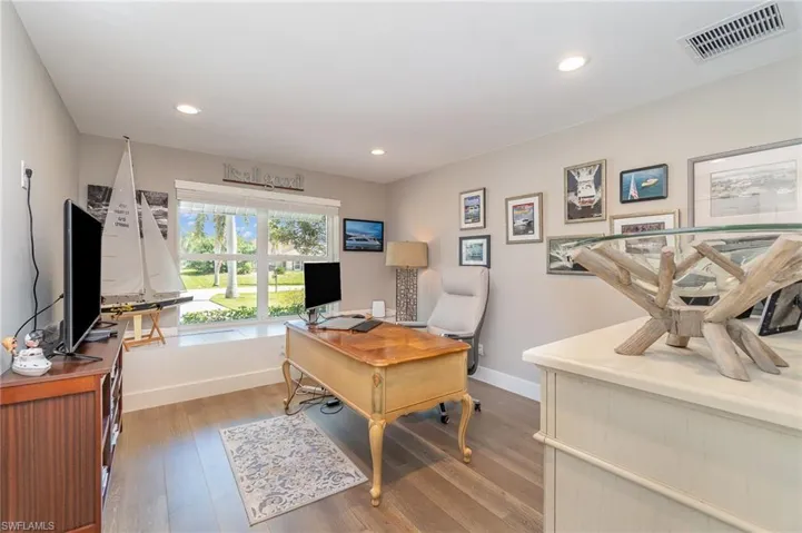 Office space with light hardwood / wood-style flooring