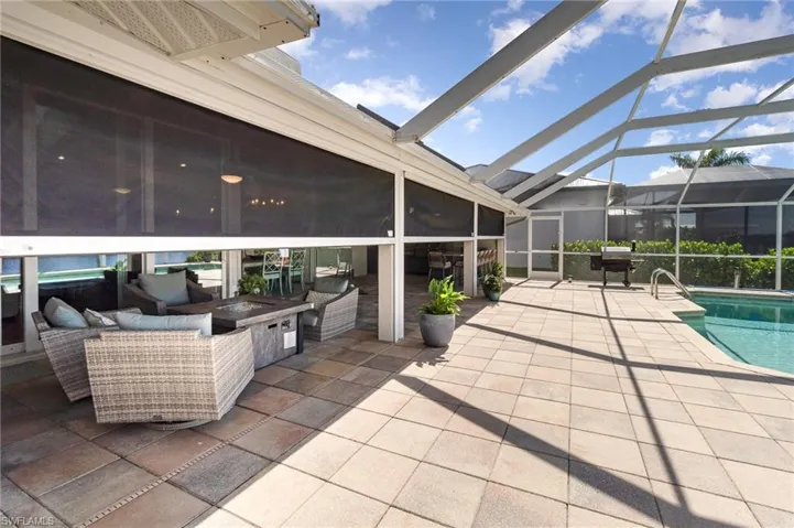 View of patio with an outdoor living space and screen enclosure
