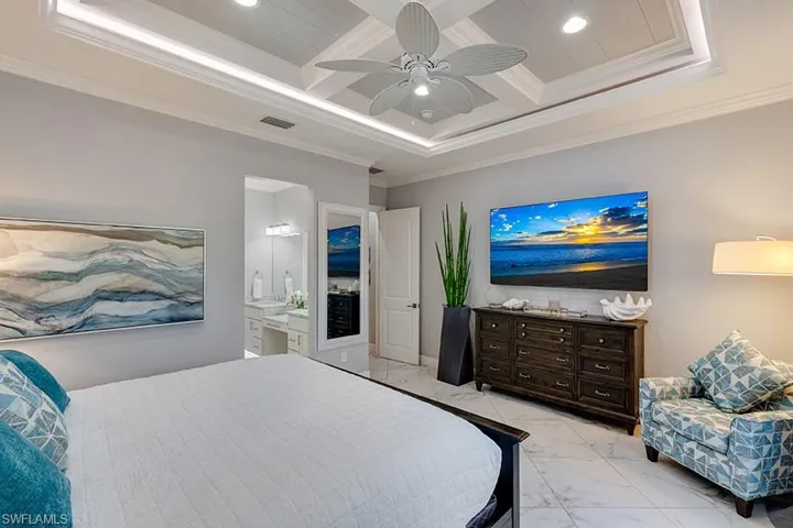 Bedroom featuring coffered ceiling, recessed lighting, ornamental molding, ceiling fan, and marble finish flooring