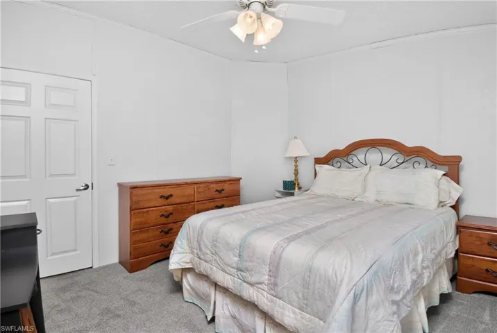 Bedroom featuring carpet, a ceiling fan, and crown molding