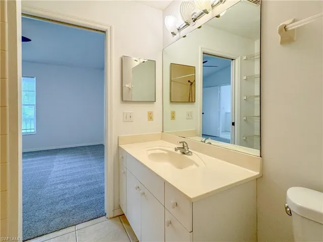 Bathroom with tile patterned floors, toilet, and vanity