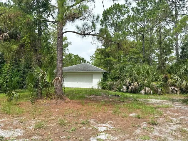 View of yard with an outbuilding and a garage