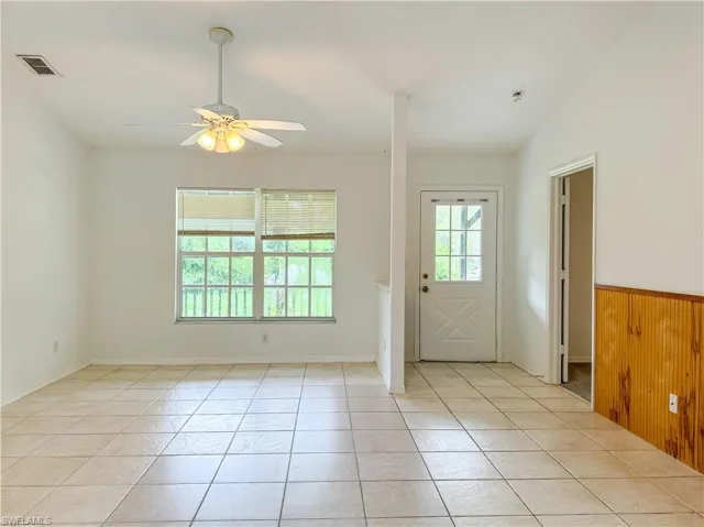 Tiled spare room with ceiling fan