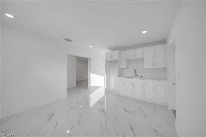 Empty room featuring baseboards and recessed lighting