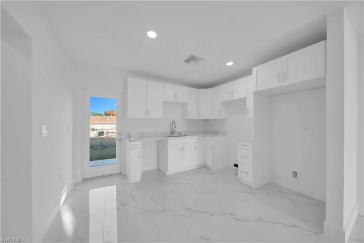 Full bathroom with vanity, marble finish floors, and bathtub / shower combination