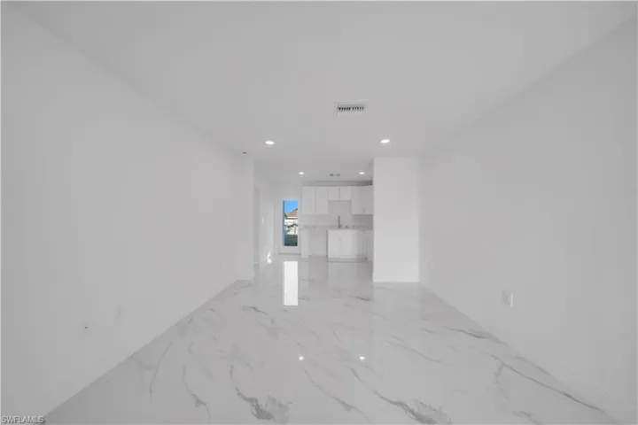 Spare room featuring recessed lighting and light marble finish floors