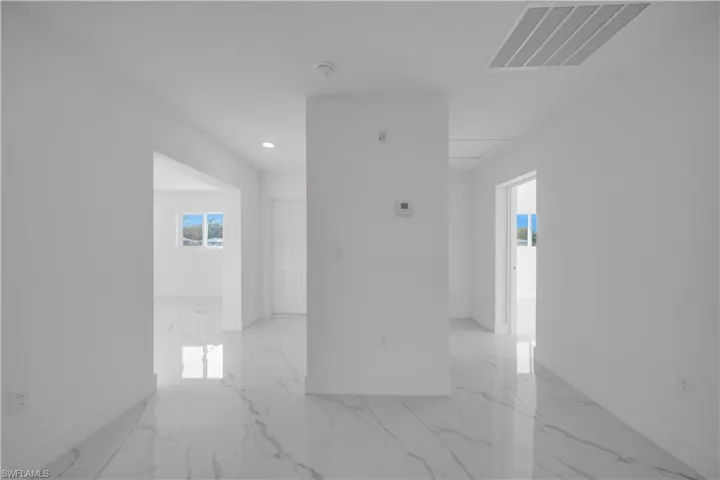 Corridor with baseboards and recessed lighting