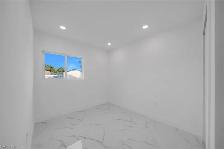 Empty room featuring recessed lighting and light marble finish floors