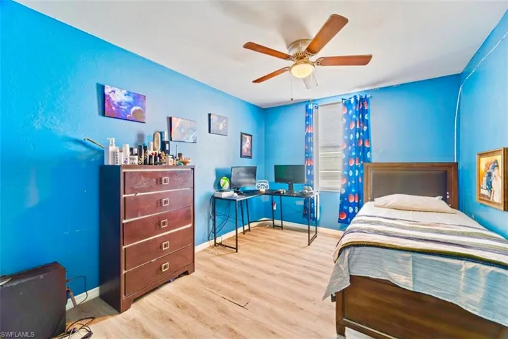 Bedroom featuring ceiling fan and light wood-type flooring
