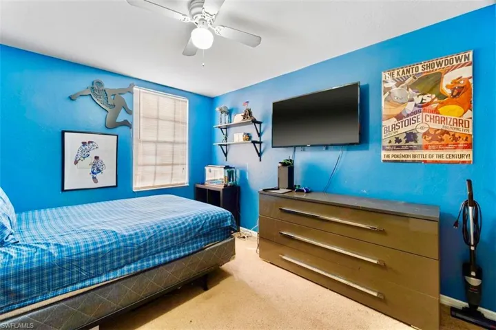 Carpeted bedroom with ceiling fan