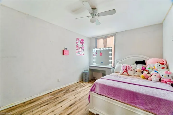 Bedroom with ceiling fan and wood-type flooring