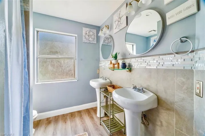 Bathroom with toilet and hardwood / wood-style flooring