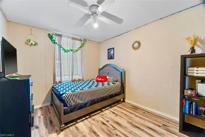 Bedroom with ceiling fan and light hardwood / wood-style flooring