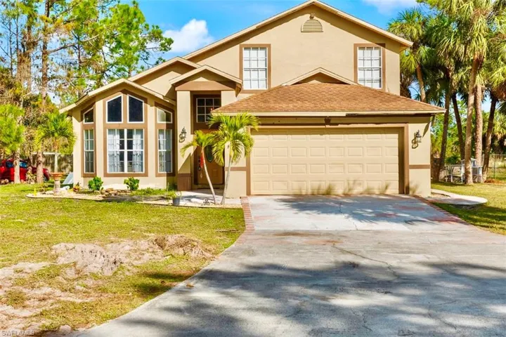 View of front of property with a garage and a front yard