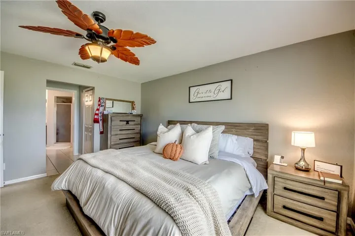 Bedroom with carpet floors, a ceiling fan, and a closet