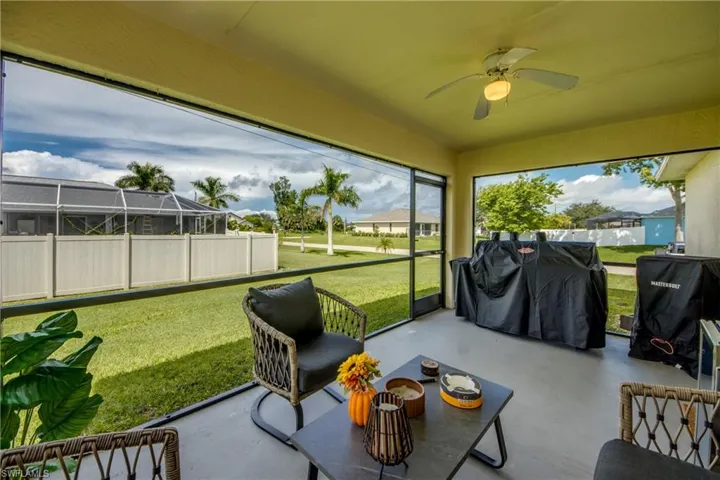 Sunroom / solarium featuring ceiling fan and a patio