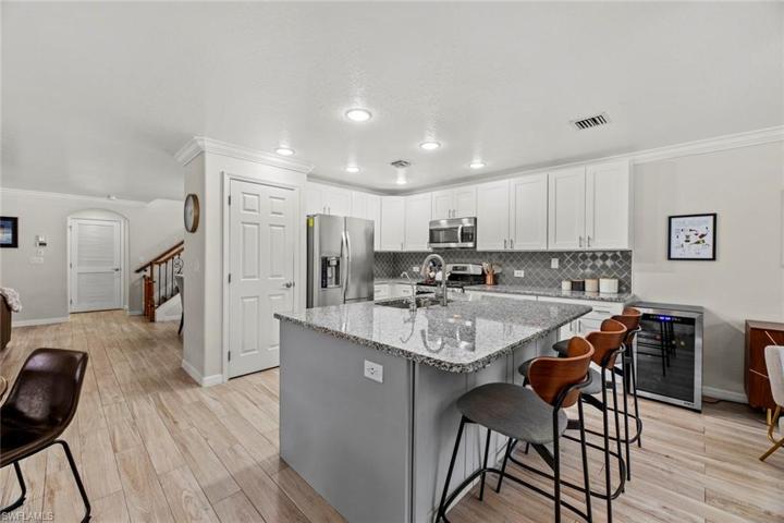 Pantry behind door next to refrigerator