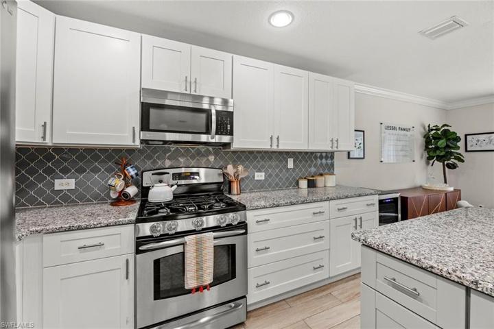 Natural gas range, granite counter top, tile backsplash