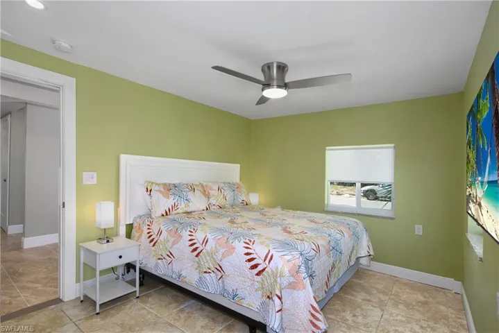 Master Bedroom: Bright bedroom with a tropical-inspired feel - Virtually Edited Image