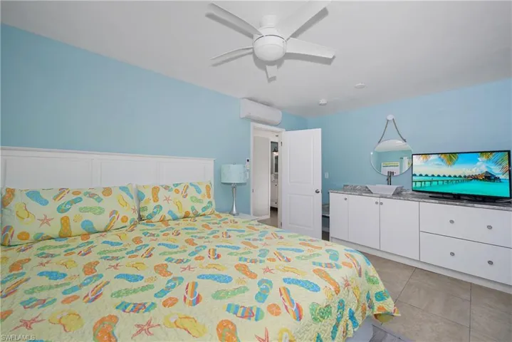 Relaxing bedroom featuring a queen bed and ample storage - Virtually Edited Image