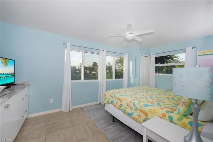 Inviting bedroom with a ceiling fan and modern amenities - Virtually Edited Image
