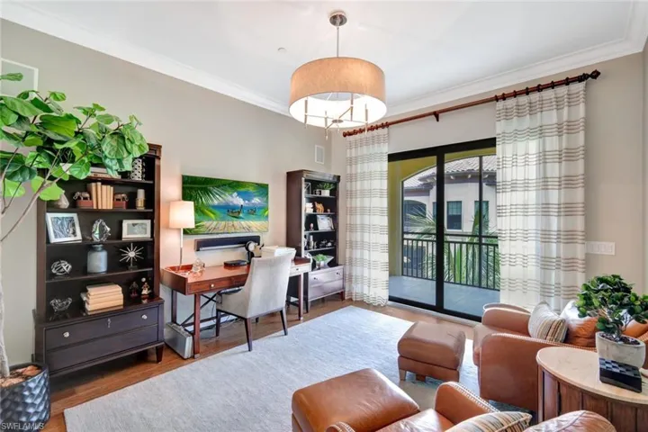Home office with hardwood / wood-style flooring and ornamental molding
