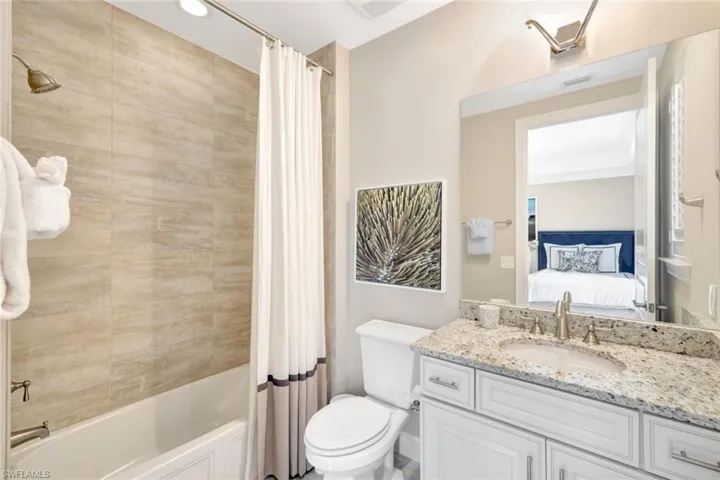 Full bathroom with toilet, shower / bathtub combination with curtain, vanity, and ornamental molding