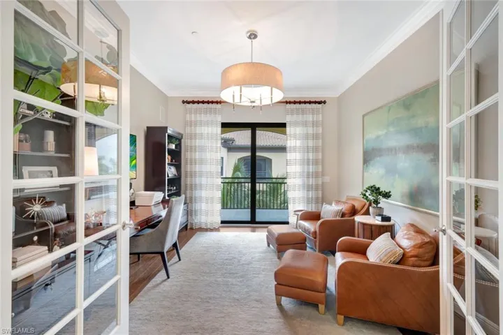 Living area with ornamental molding, french doors, and hardwood / wood-style floors