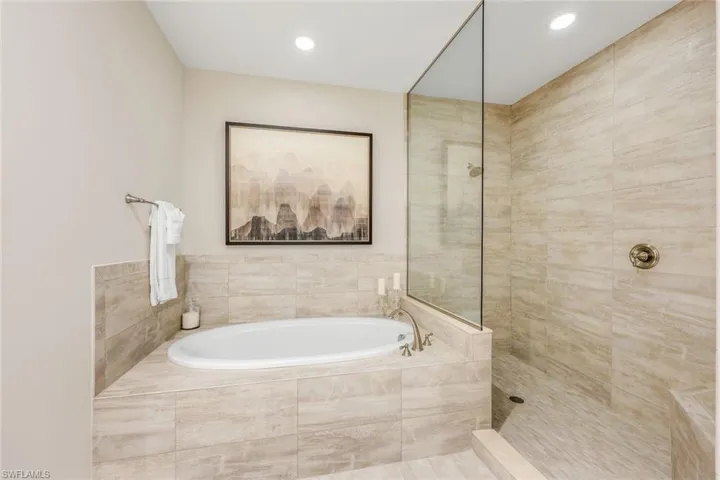 Bathroom featuring shower with separate bathtub