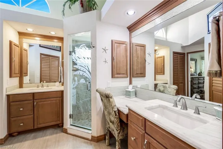 Bathroom with hardwood / wood-style flooring, vanity, and walk in shower