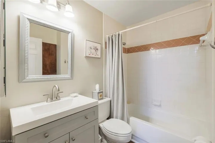 Full bathroom featuring shower / tub combo, vanity, and toilet